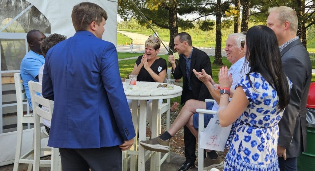 David Farr performing strolling magic for guests on an outdoor patio