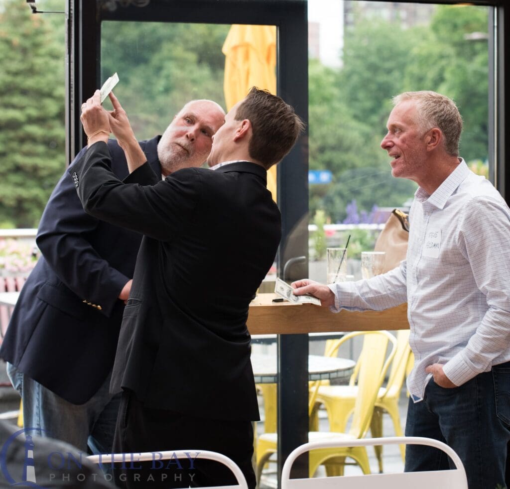 Guests taking a selfie with magician David Farr at an event
