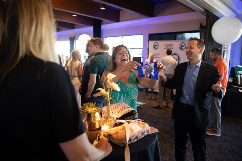 Guests laughing and mingling at a corporate event