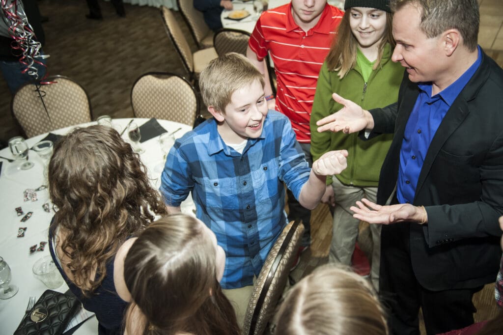 David Farr performing close-up magic for children at a party