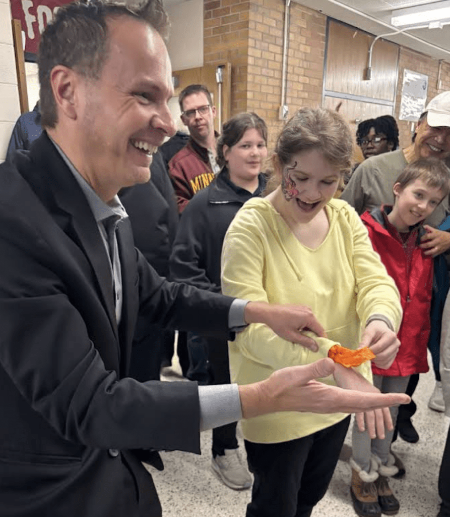 David Farr performing close-up magic for students
