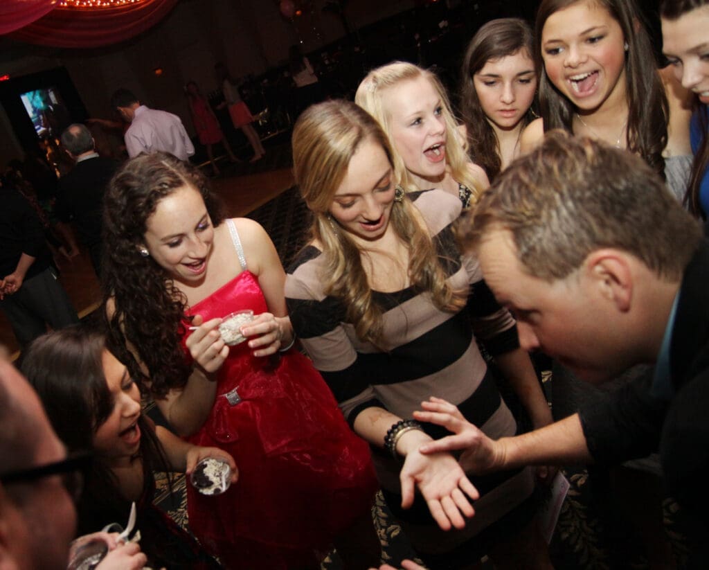 David Farr performing close-up magic for a group of guests